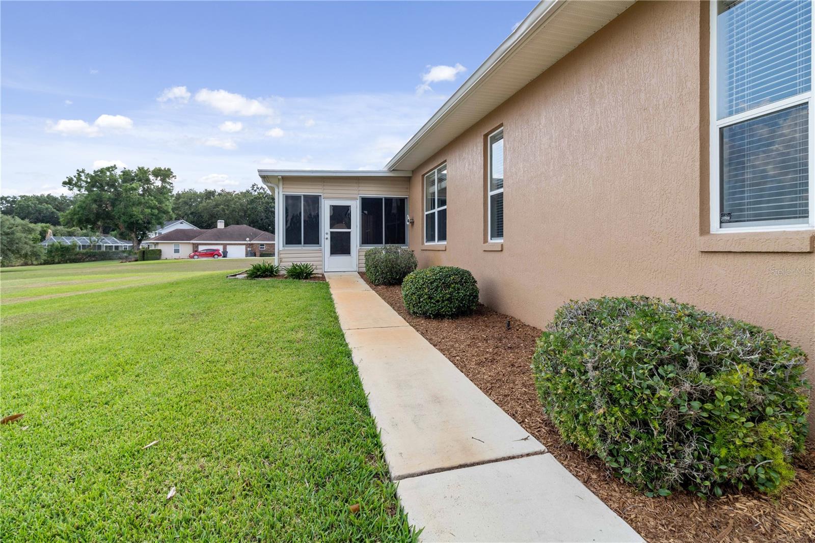 The backyard is on the East side of the house - walkway leads to the back enclosed porch