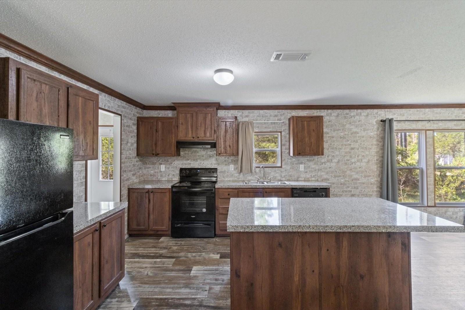 Kitchen w/ Island &amp; Laminate Flooring