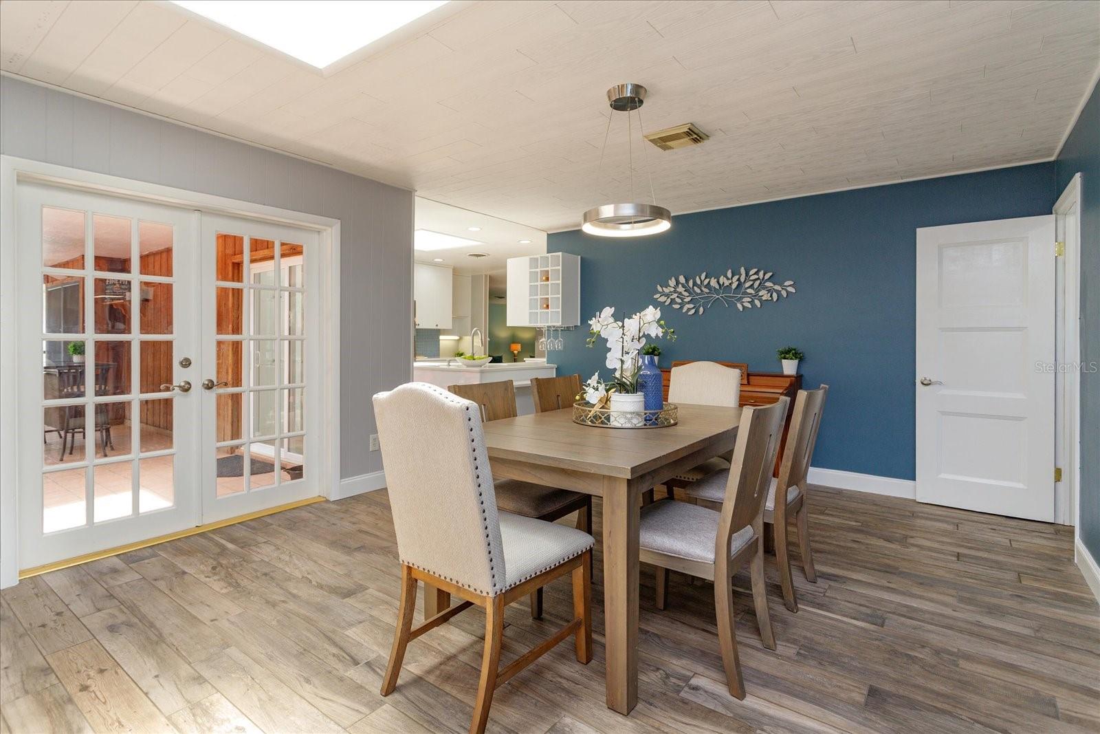 15 x 13 dining room with tongue and groove ceiling and french doors leading out to the lanai.