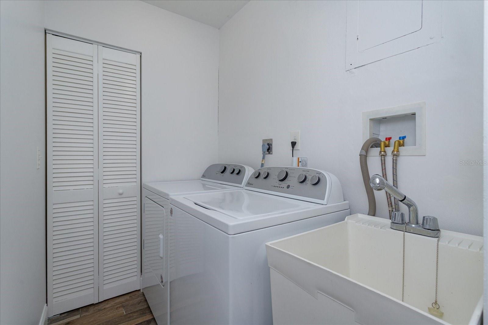Interior laundry with 2 storage closets and a utility sink