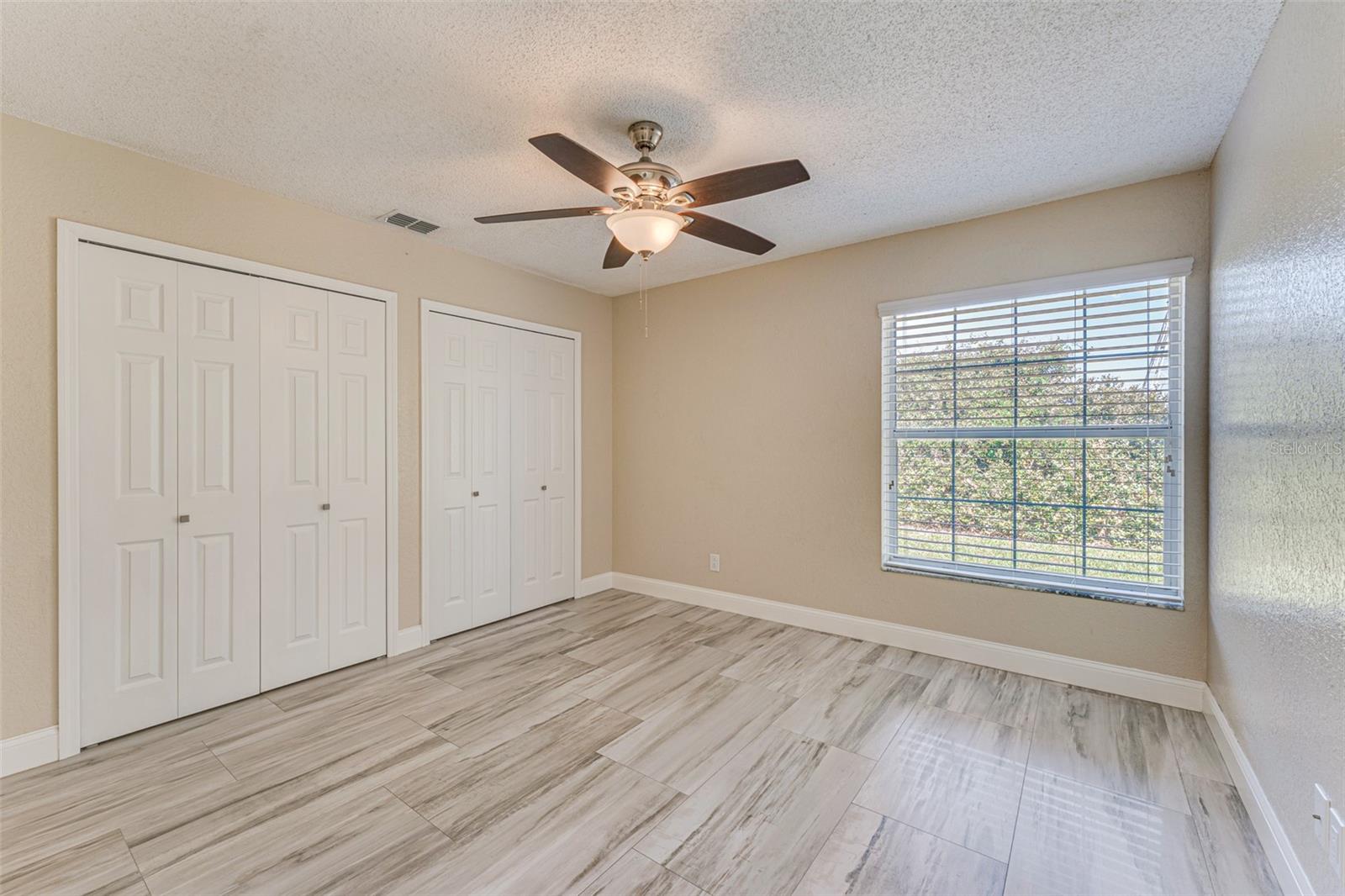 Bedroom #2 features ceiling fan and two built-in closets