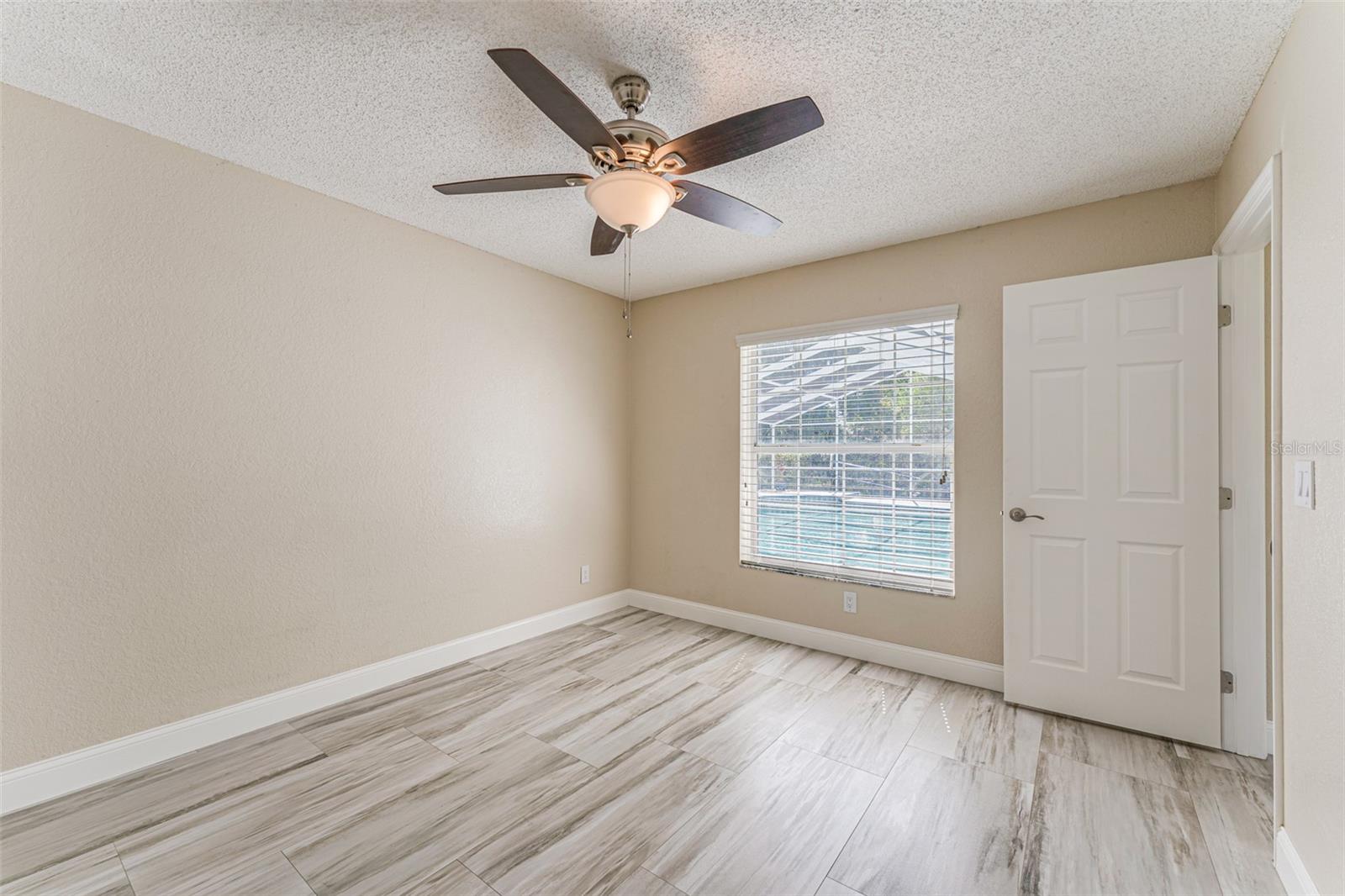 Bedroom #3 with window overlooking pool