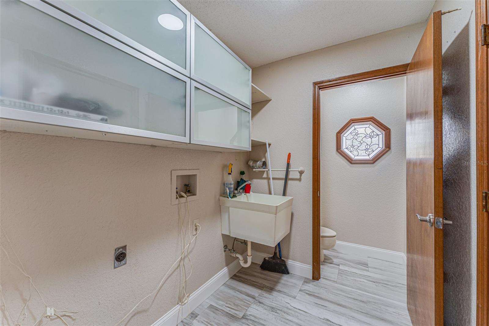 Laundry room is situated between the garage and kitchen