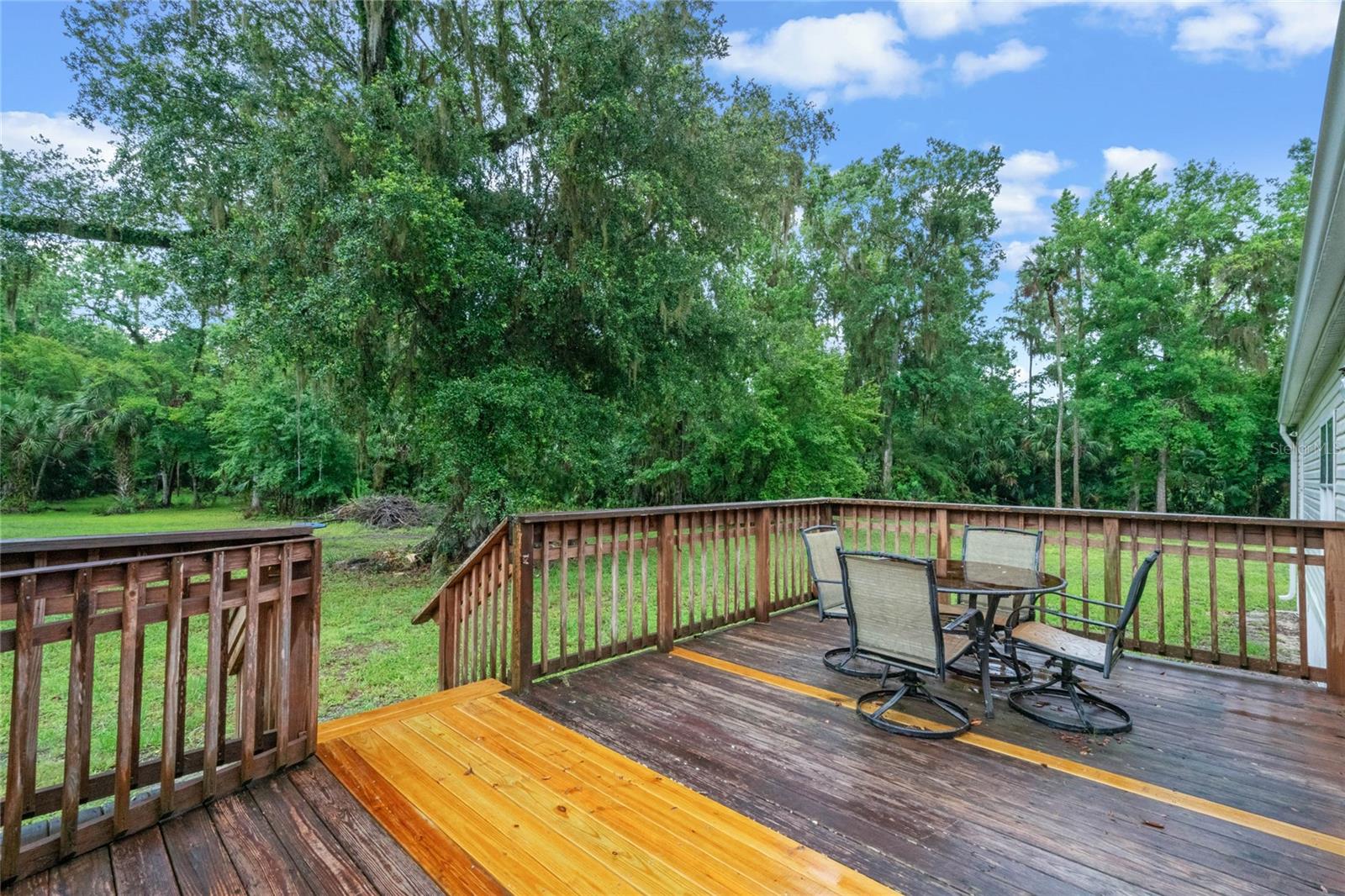 Access the wood deck and gorgeous backyard from the sliding glass doors in the family room.
