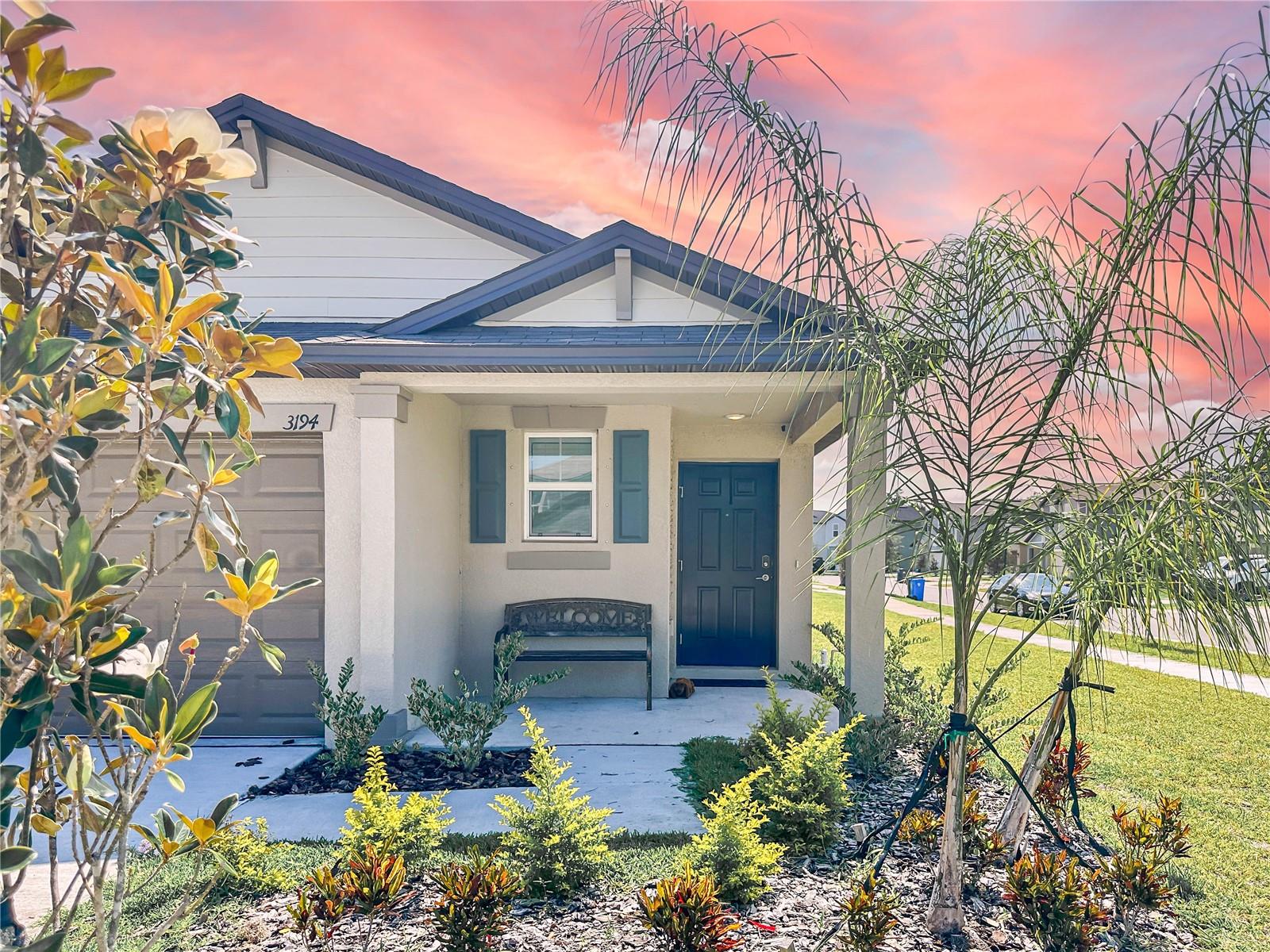 Covered entryway provides a restful nook to enjoy morning coffee.