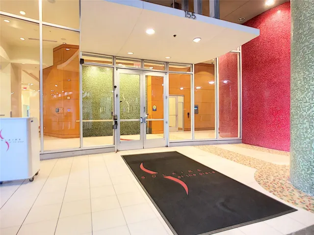 Covered entry with security features and doorman.