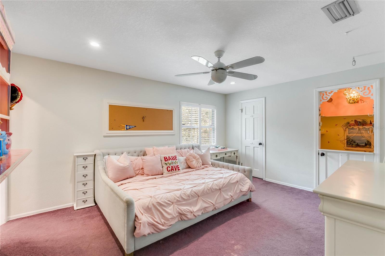 Bedroom with walk-in closet and and playroom