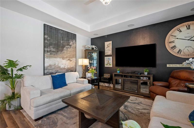 Tray ceilings with recessed lighting highlight this incredible living space.
