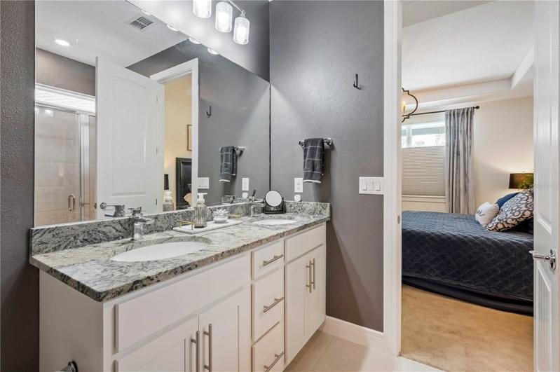 Master retreat has double vanity, Granite counters, tile flooring, and step-in shower.