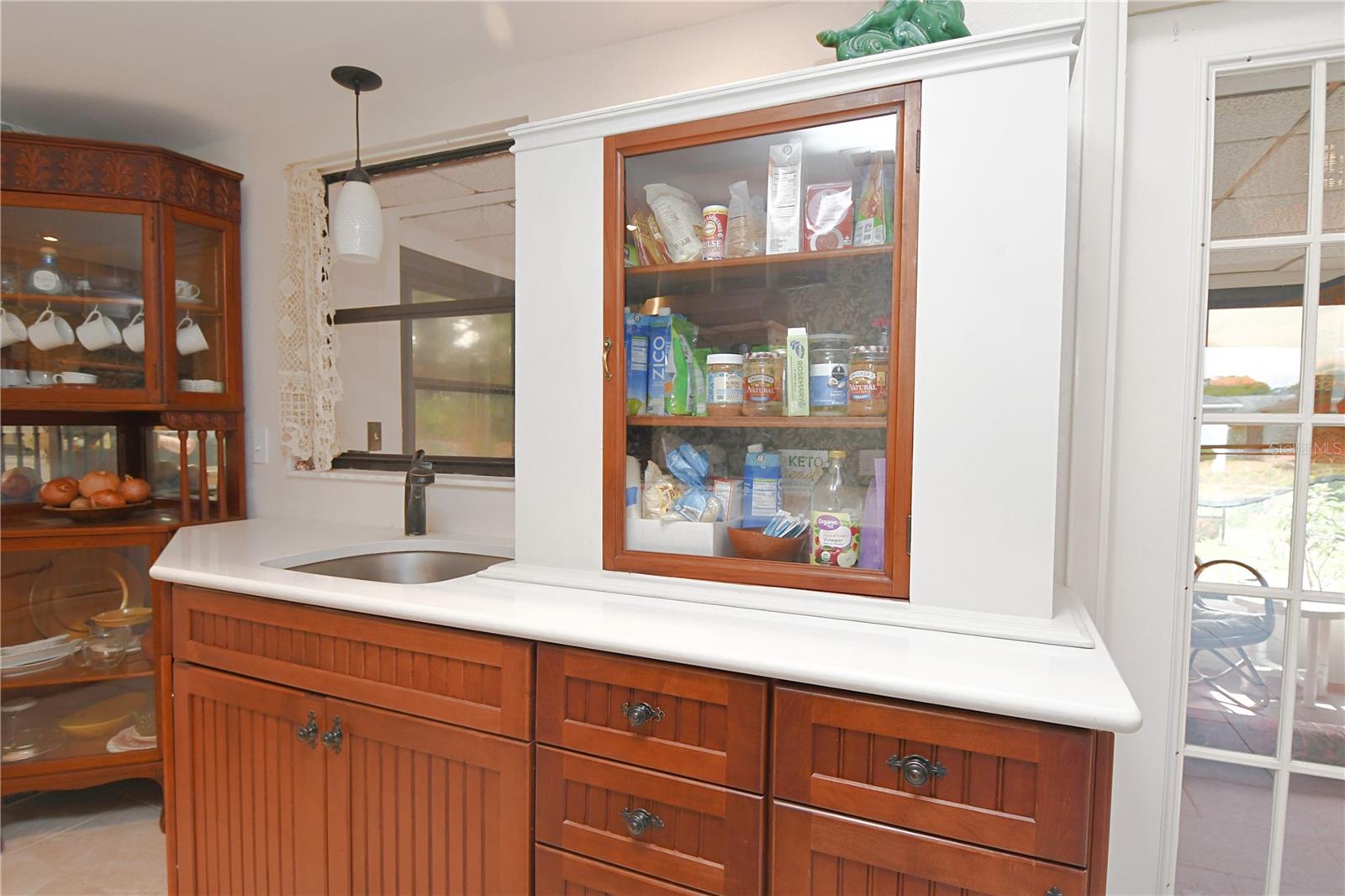 There's a stainless steel sink with a window above it.