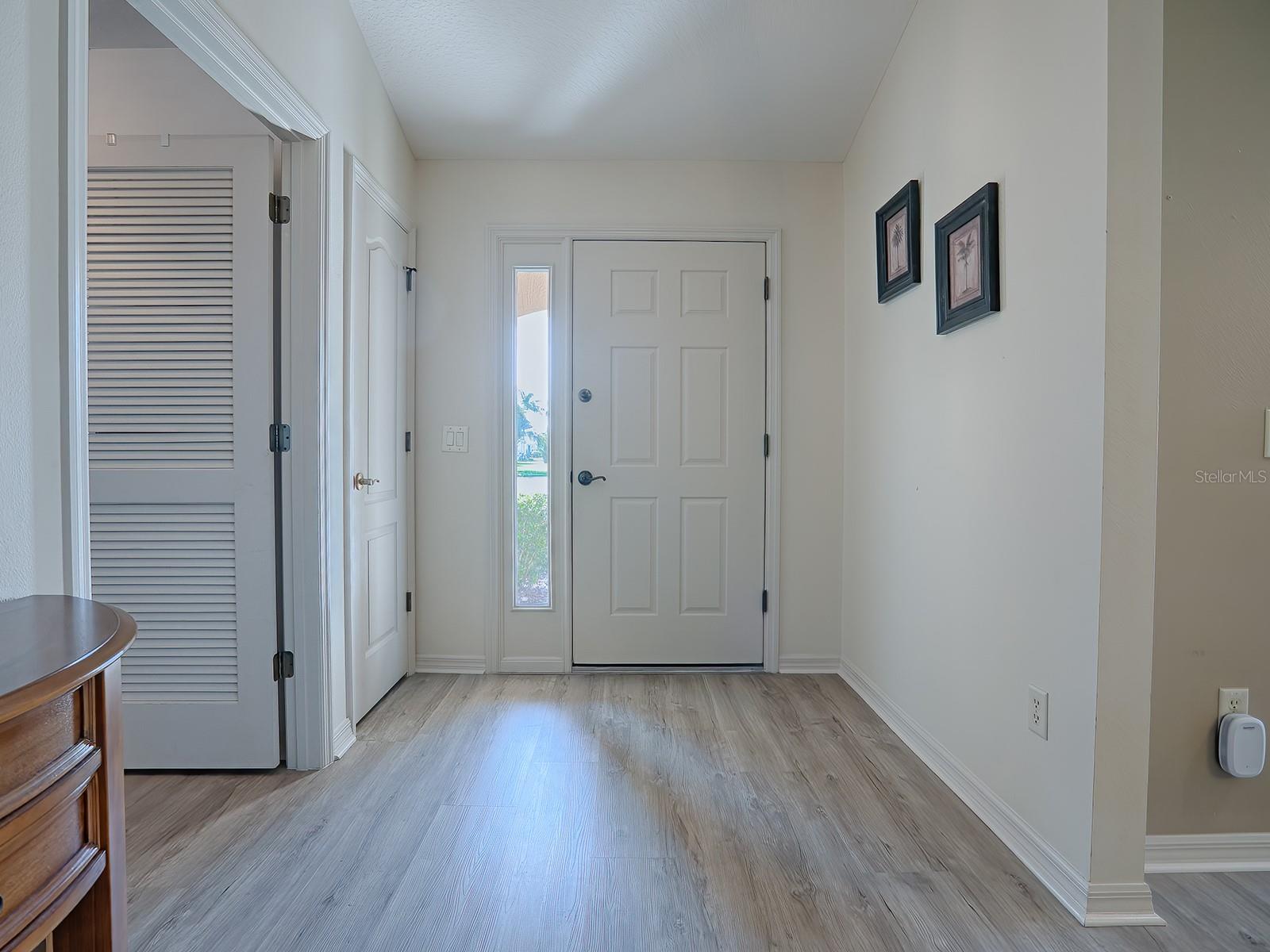 Foyer with door leading to inside laundry
