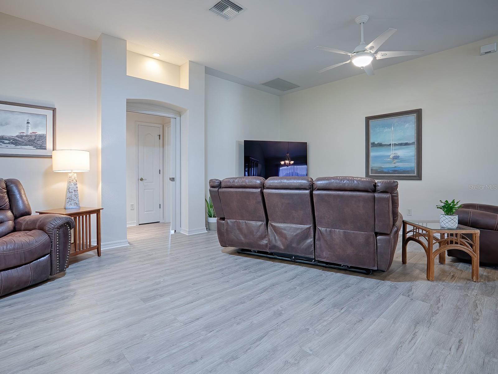 Living with entrance to guest bedrooms/bathroom with pocket door for privacy
