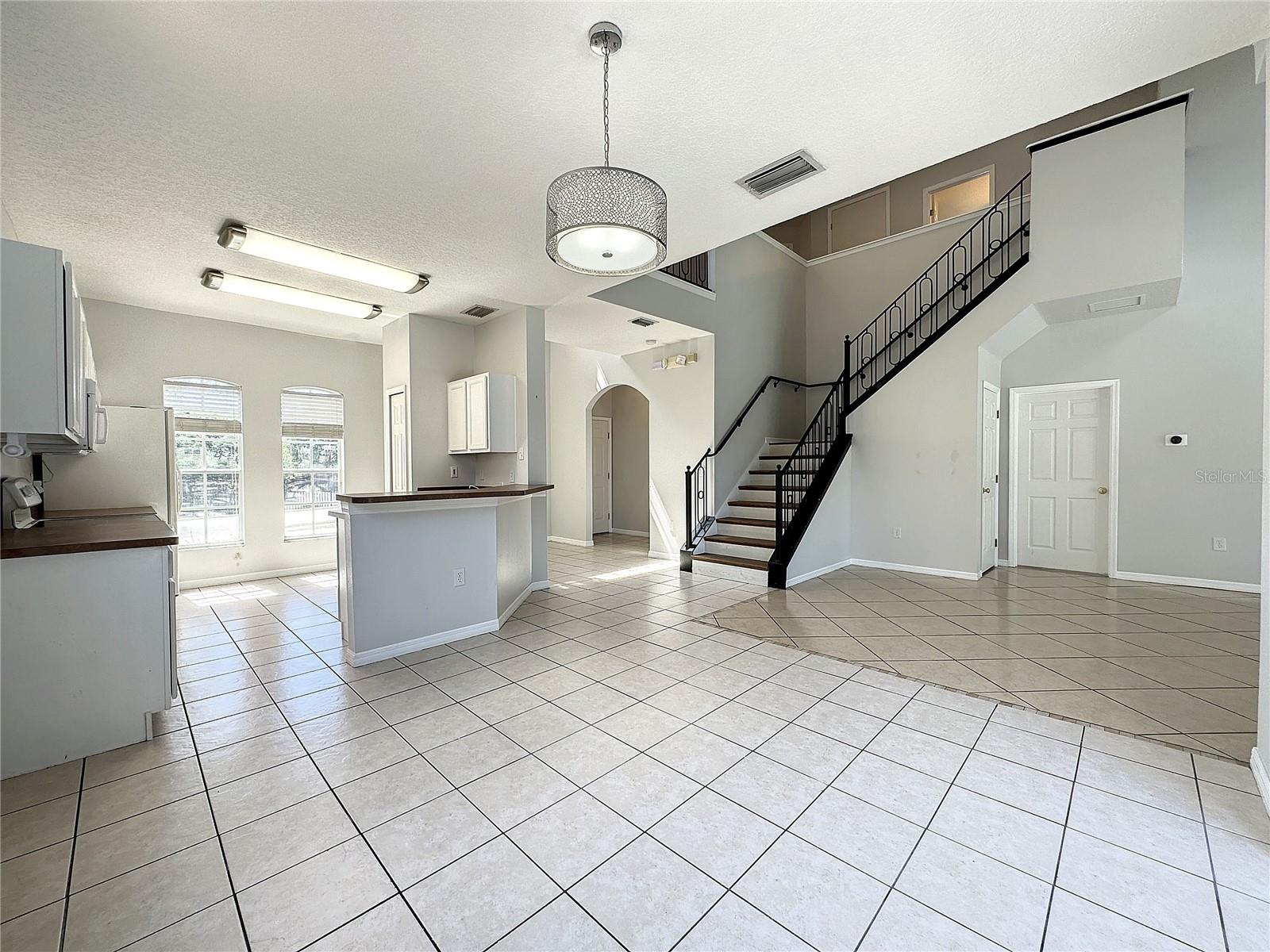 Dining area opening to kitchen and views of pool