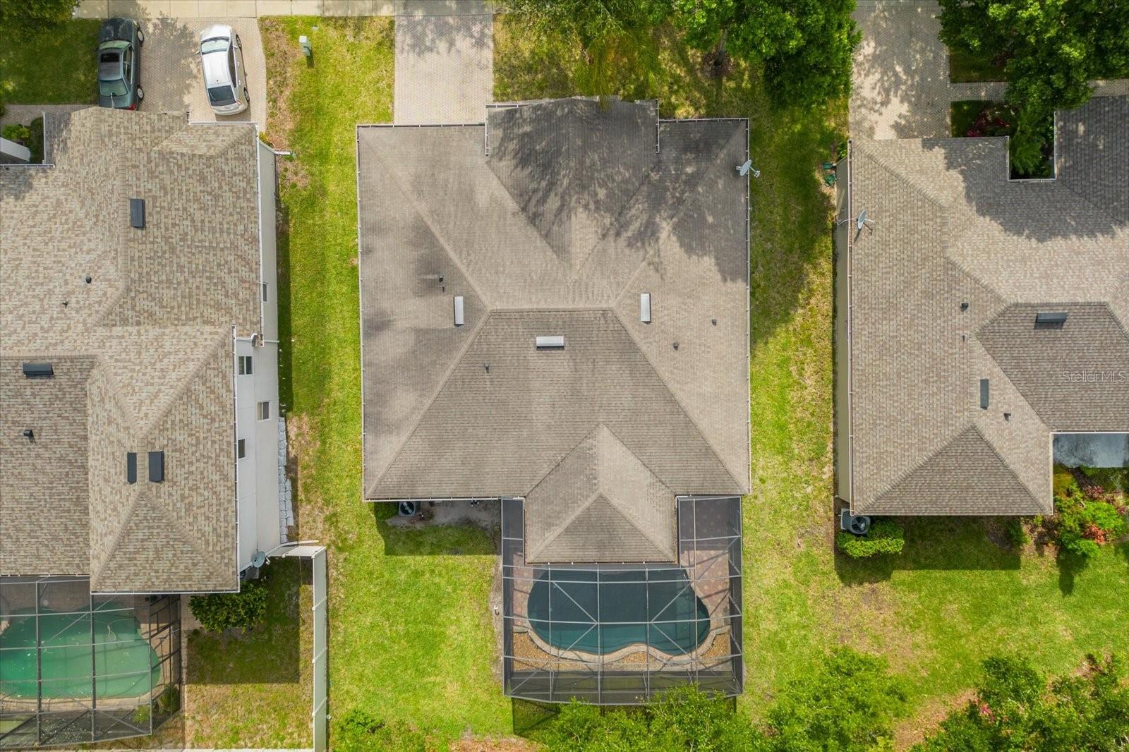 Aerial shot of the home and side yards, pool area and back.