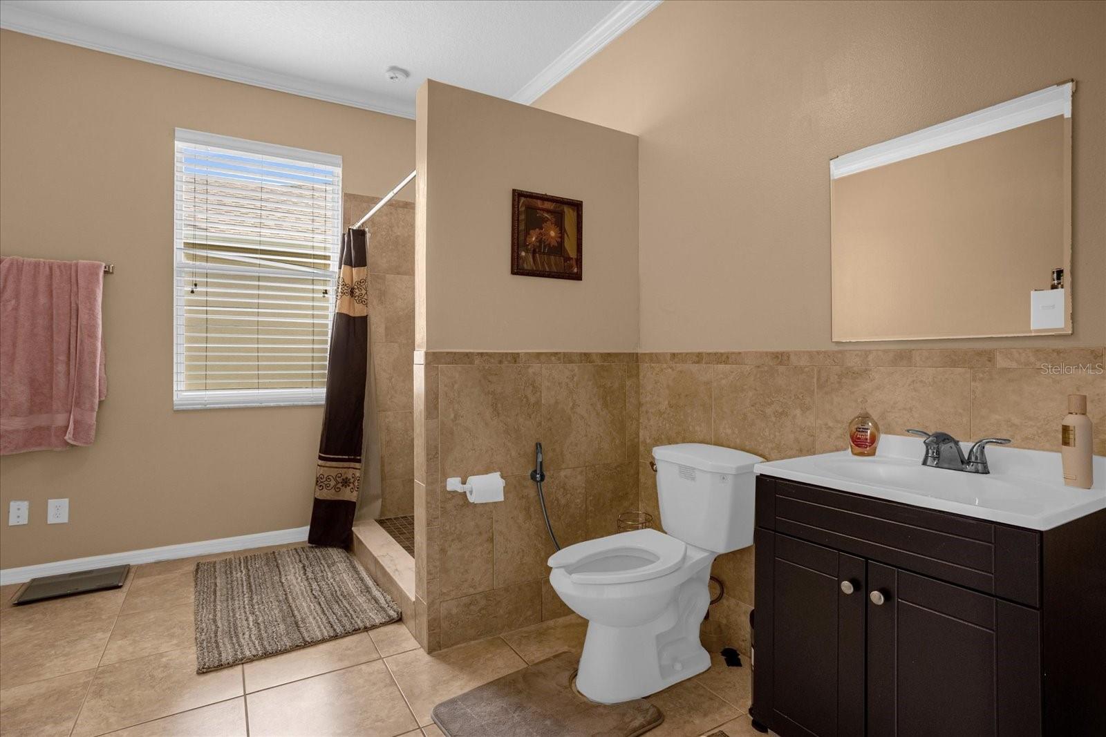 Bonus bathroom near main part of the home with walk in shower, extra storage space and double doors from common area. Bathroom 3