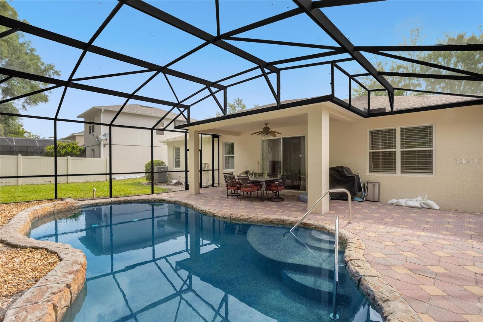 Lanai and Pool area with back lawn area