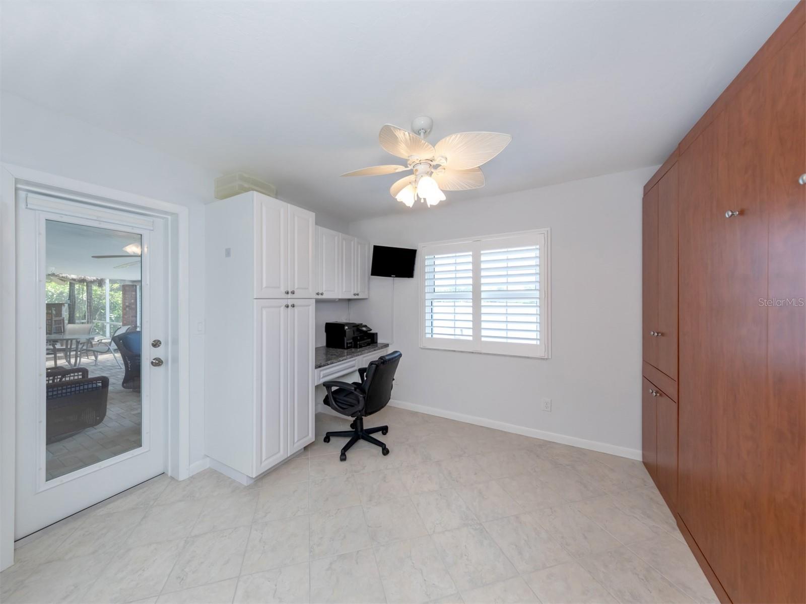 Lanai access and bay view from the bonus room with Murphy bed and built-in desk.