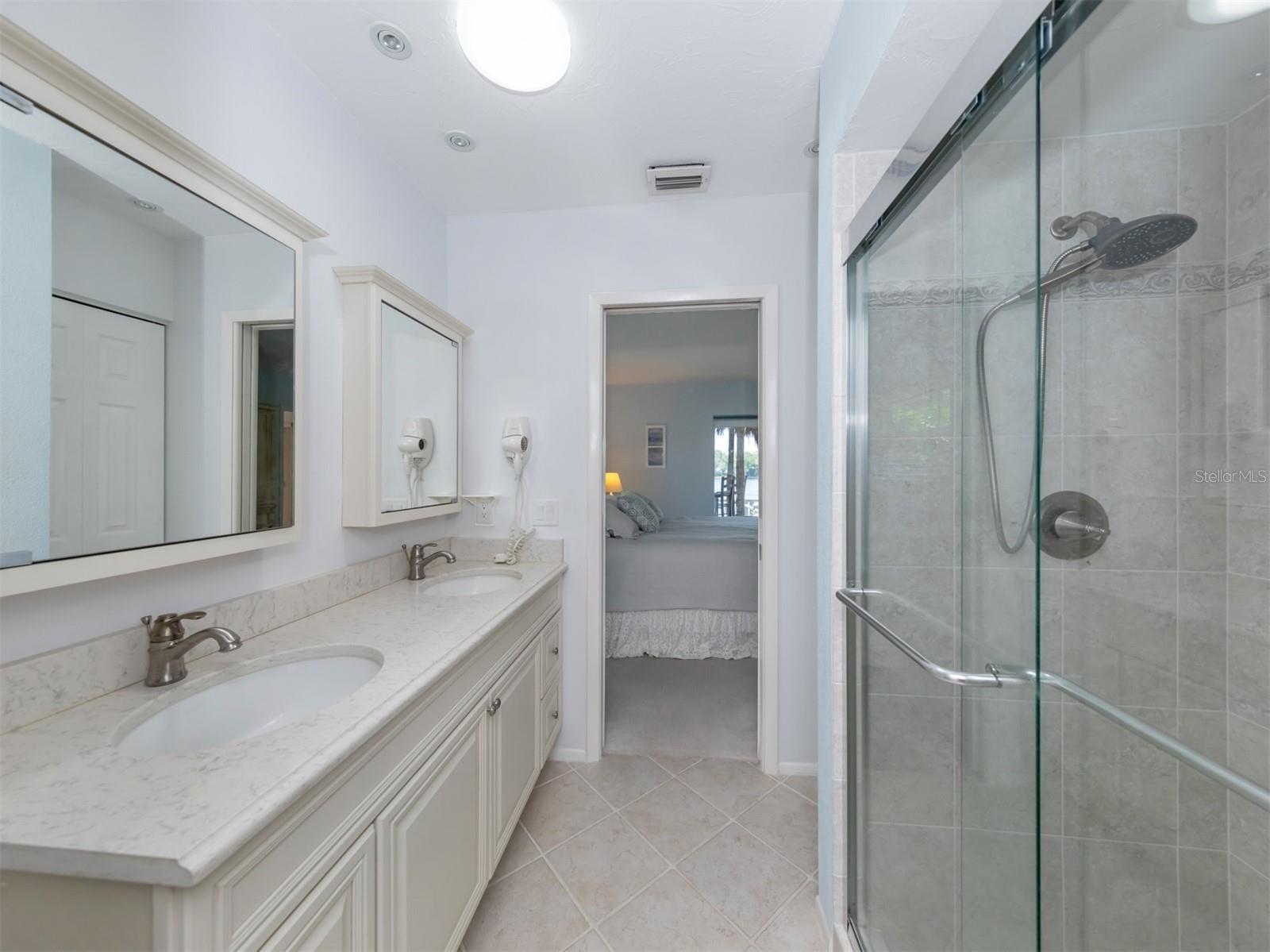 Master bath with dual sinks and walk-in shower.