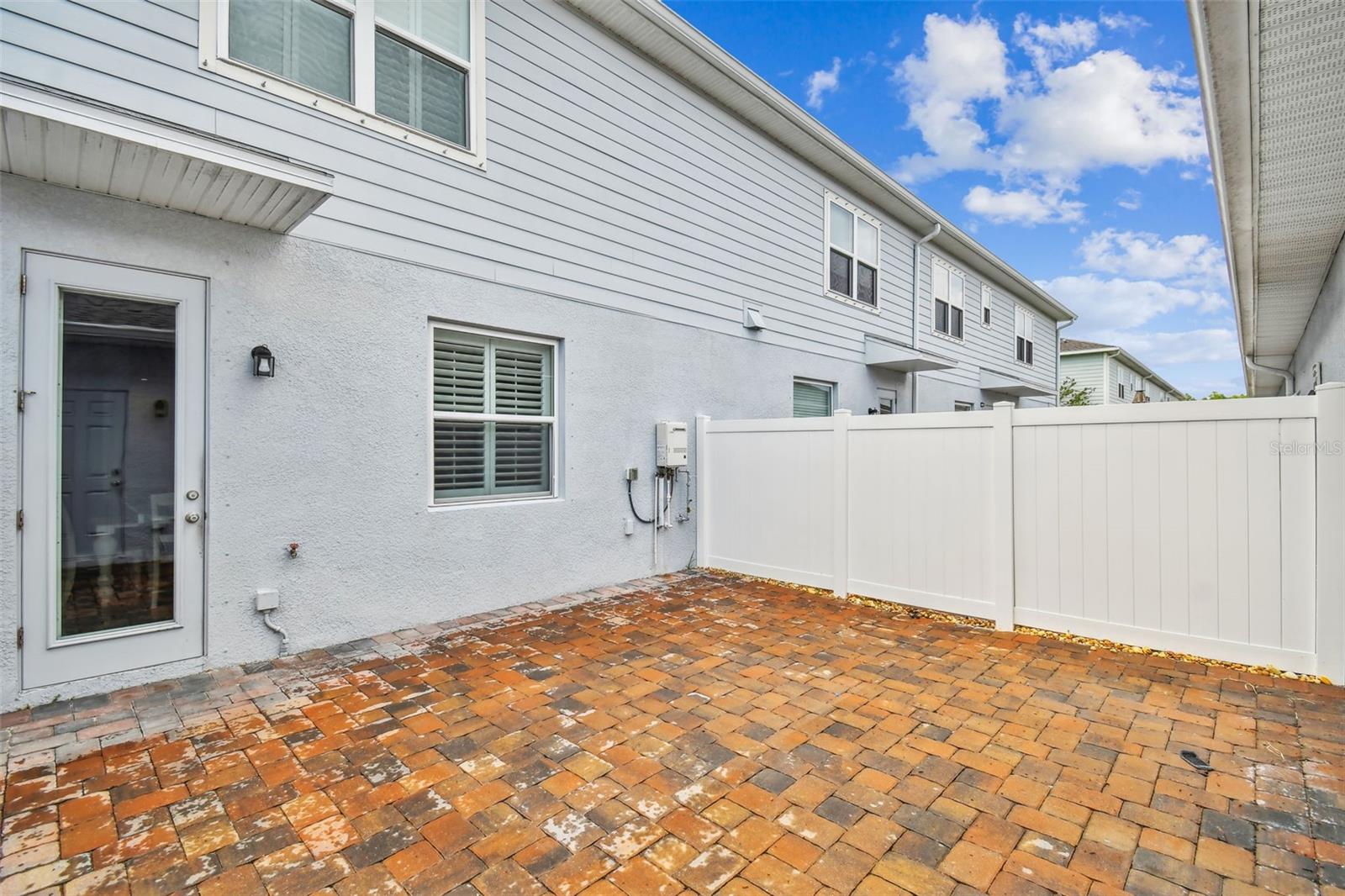 Fenced courtyard leads to garage