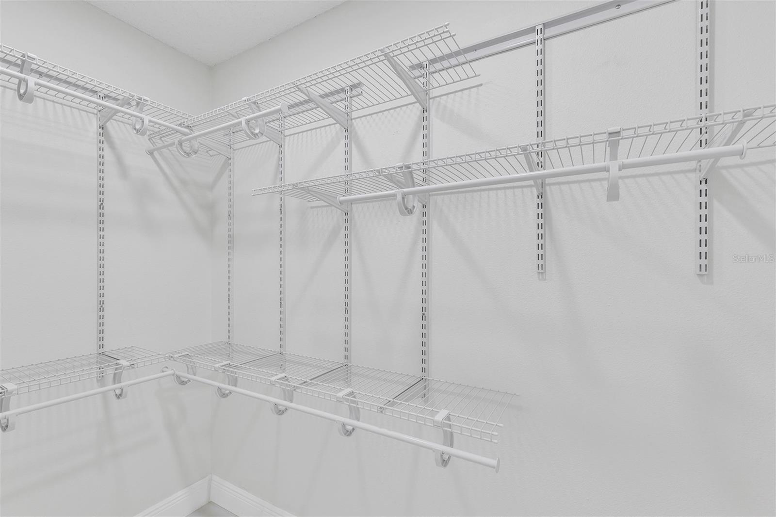 Walk-in closet in the master bedroom with shelves ready to go.