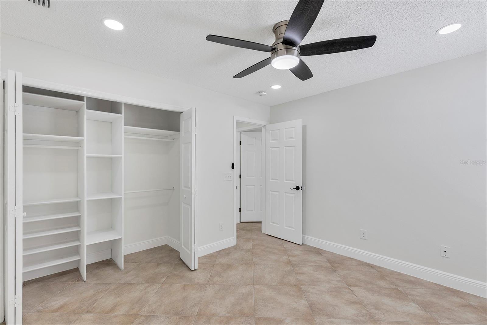 Bedroom #4. Ceramic tiles, ceiling fan, LED lights and built-in closet.