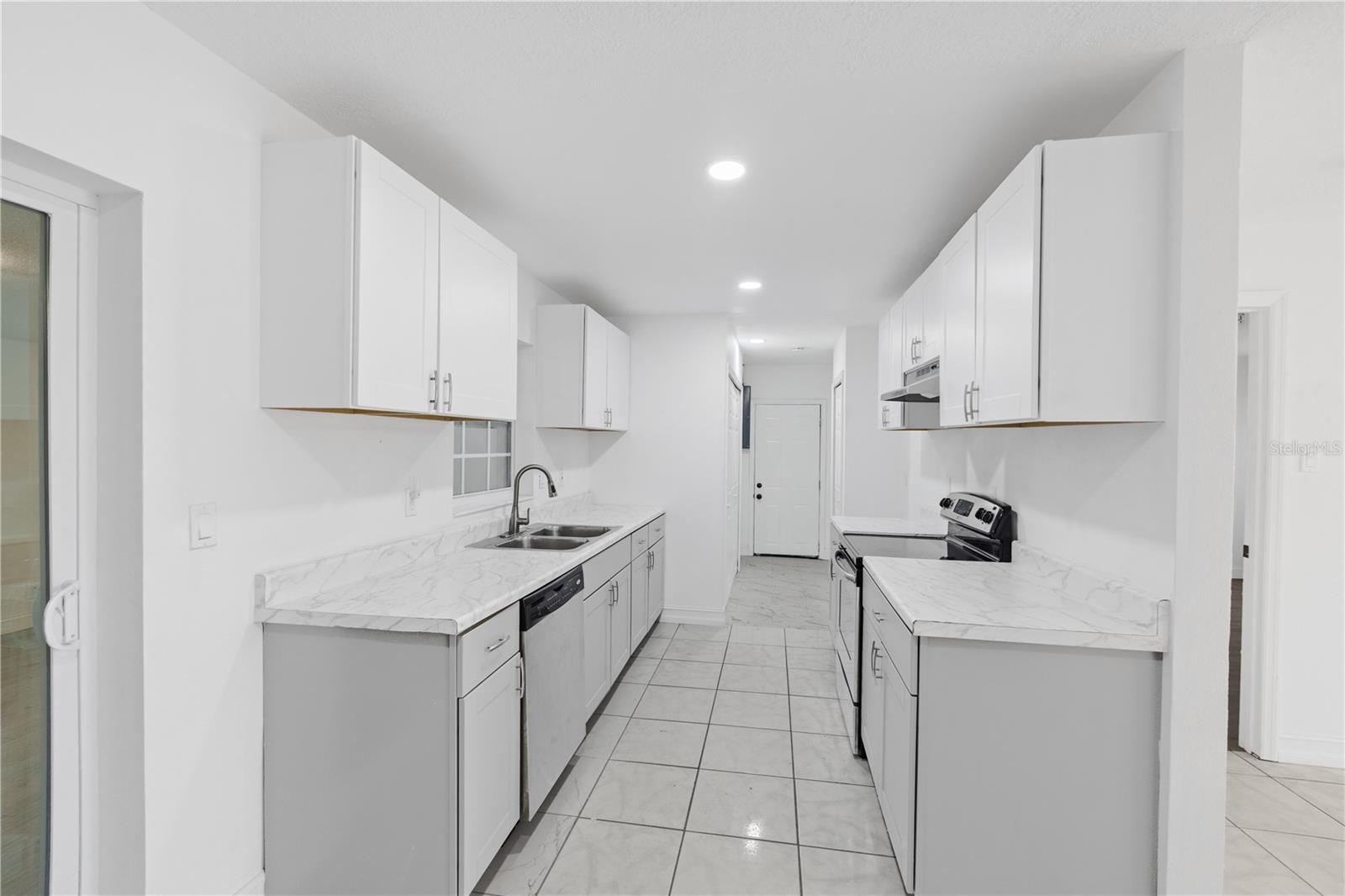 Kitchen with pantry and W/D hookups inside.