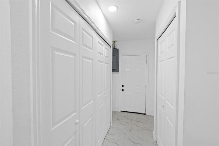 W/D hook ups to left and pantry storage on the right.