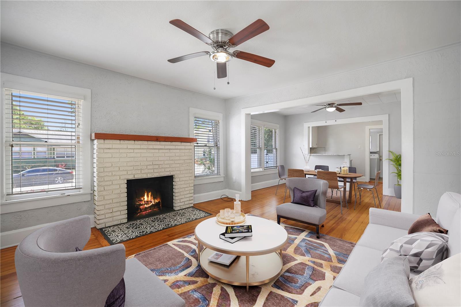 Brick Firplaeced living room with Hardwood floors, vitually staged