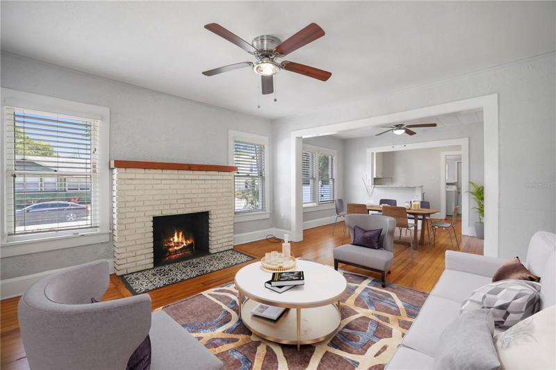 Brick Firplaeced living room with Hardwood floors, vitually staged