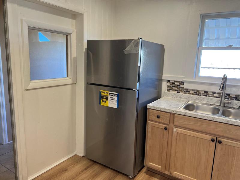 Door to the left leads to the master suite, master bath and the inside laundry area.