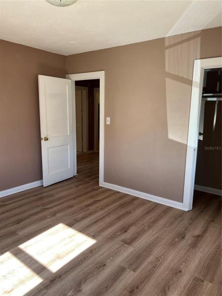 Bedroom #2 showing closet and door leading out to the hallway.