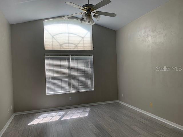 Master bedroom that is large with high ceilings
