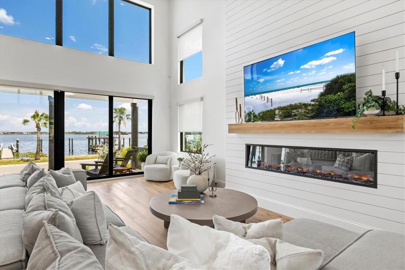 Living room with cozy fireplace feature. Clerestory windows provide additional natural light.