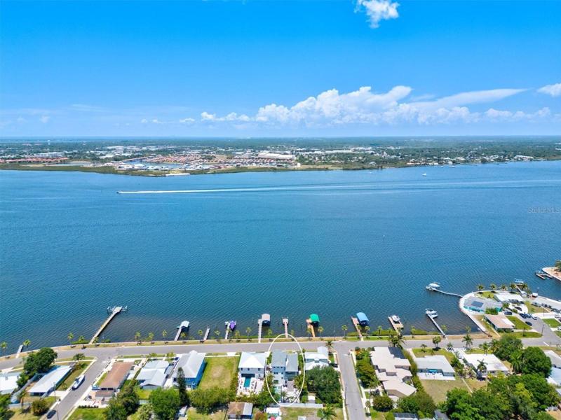 Aerial view of home with river beyond.