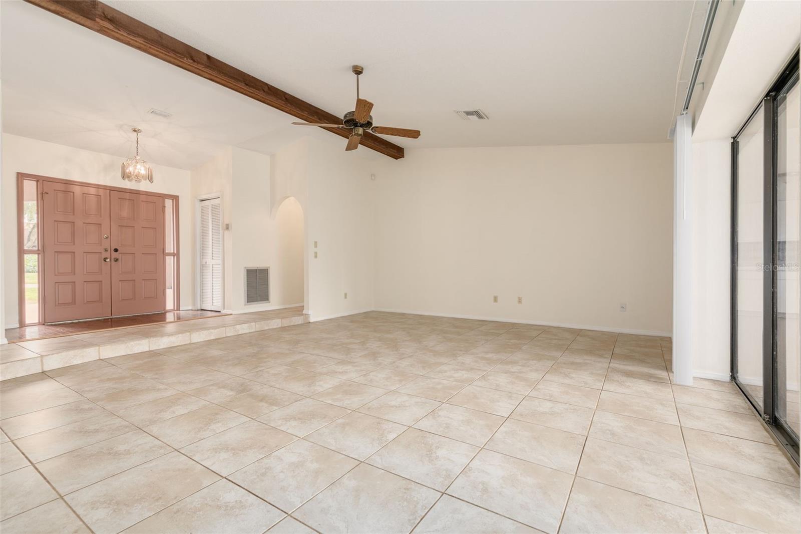 Expansive sunken living room that overlooks the lanai and pool!