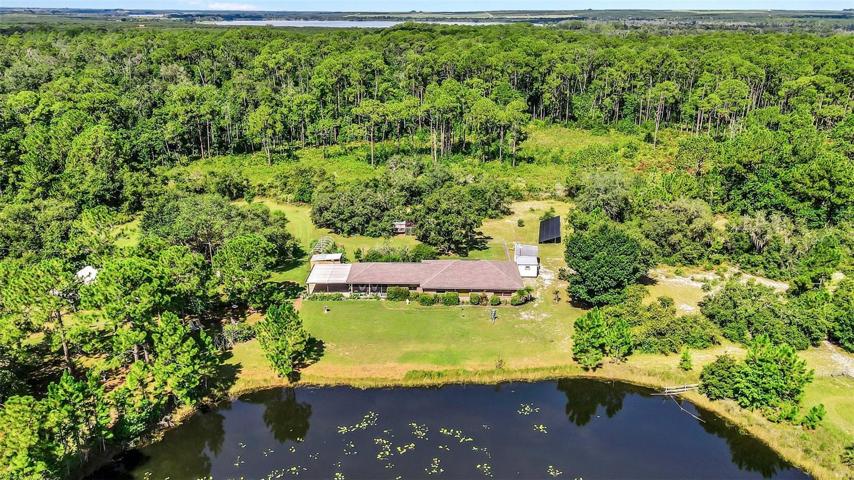 Front of home showing the thousands of acres of conservation land to the rear of the property, and a stocked lake to the front of the home.