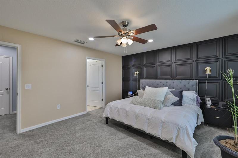 A large master bedroom with large master bathroom, dual sinks