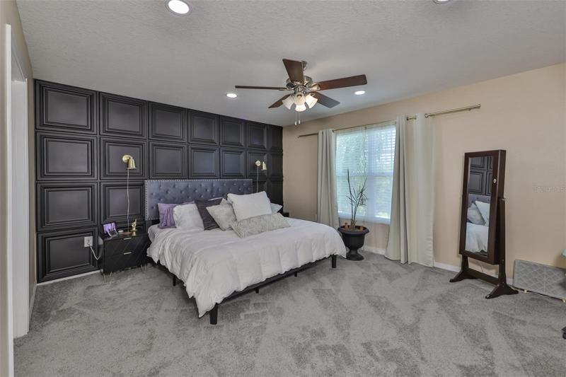 A large master bedroom with large master bathroom, dual sinks