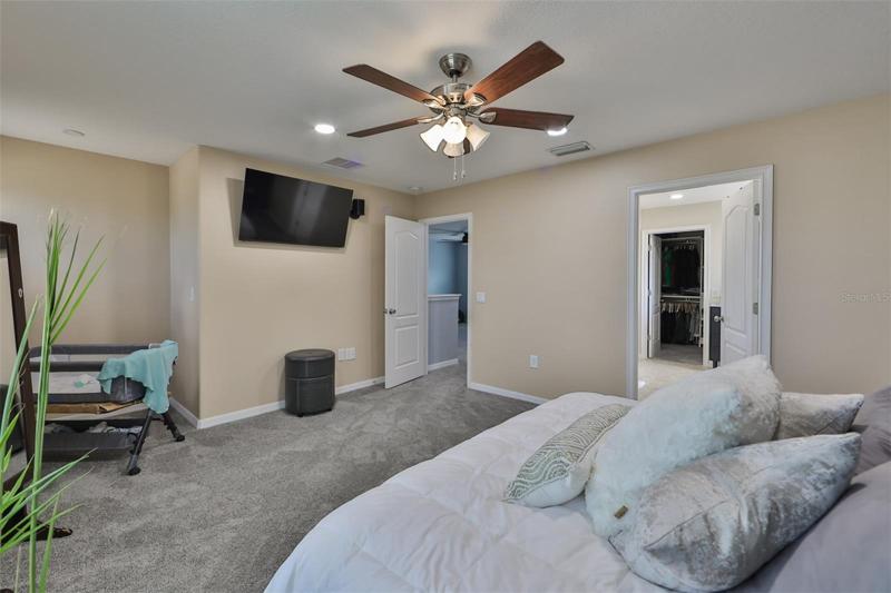 A large master bedroom with large master bathroom, dual sinks