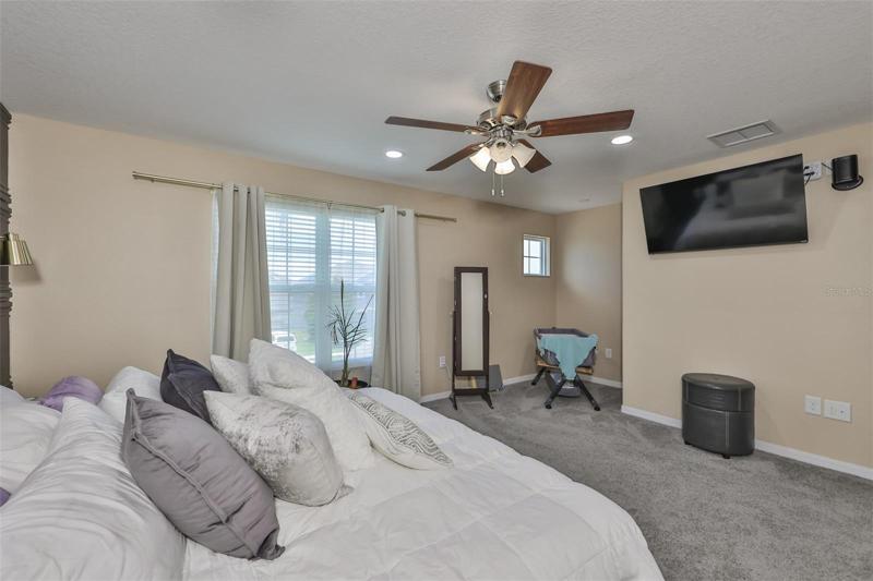 A large master bedroom with large master bathroom, dual sinks