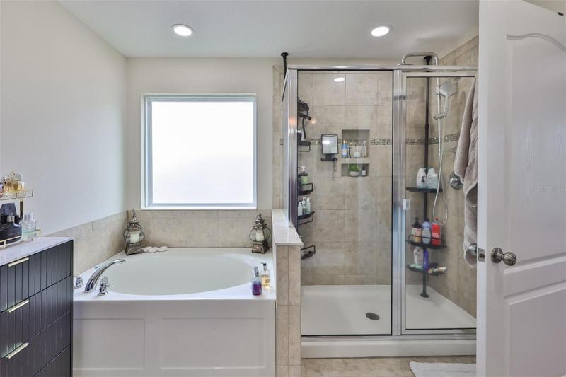 The master bath has vanity area with twin sinks and private area with walk-in shower