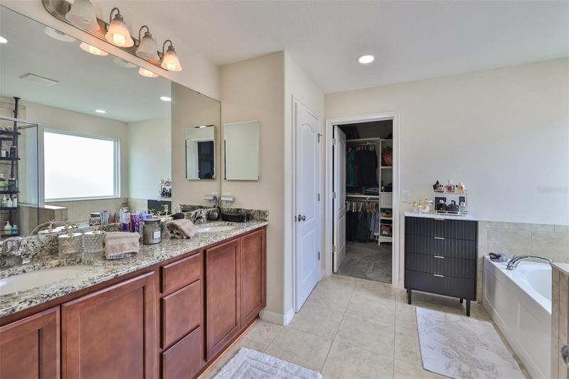 The master bath has vanity area with twin sinks and private area with walk-in shower