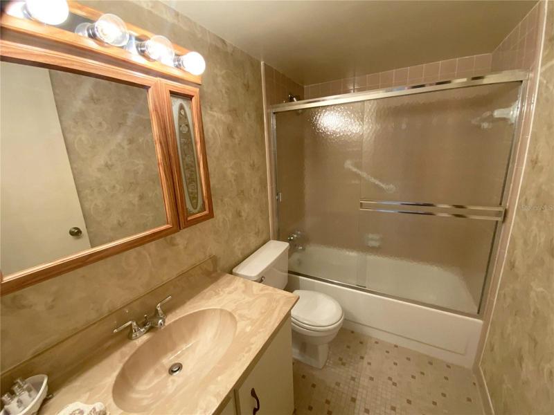 Guest bath. Full tub and easy care maintenance.