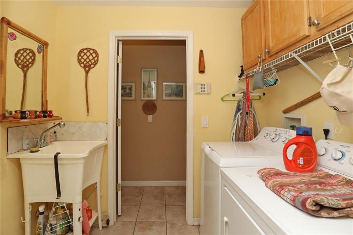 inside laundry with sink and cabinets