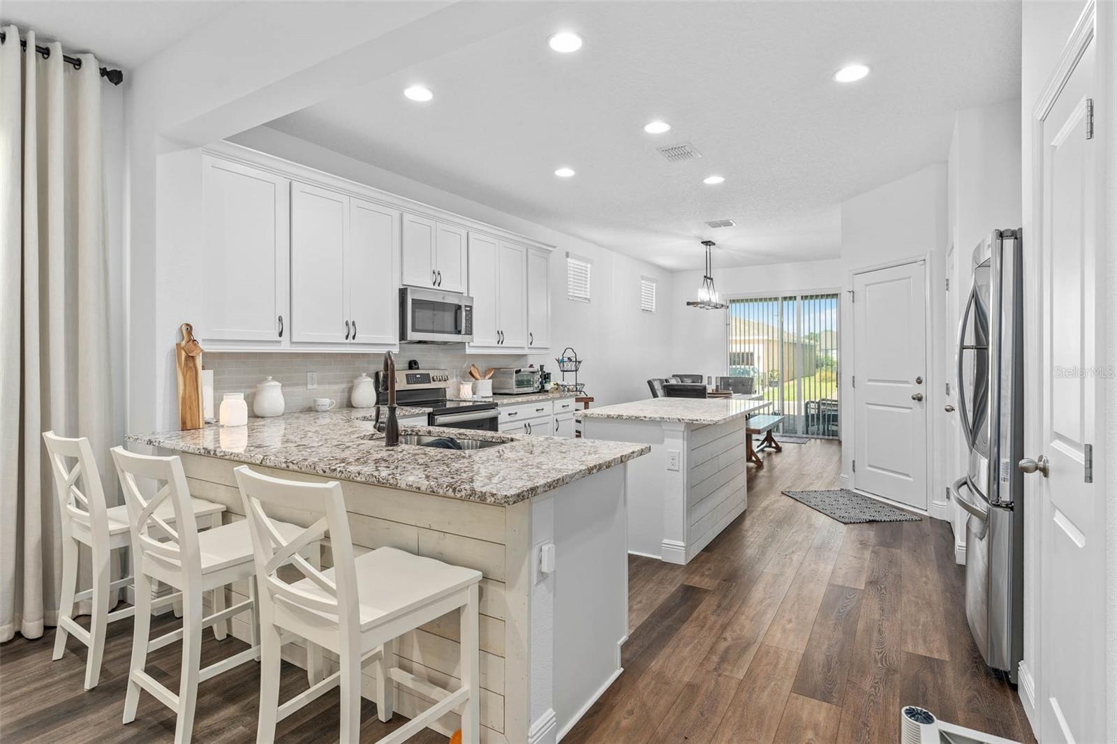 gorgeous cabinetry and granite countertops. custom woodwork and a large island with storage.