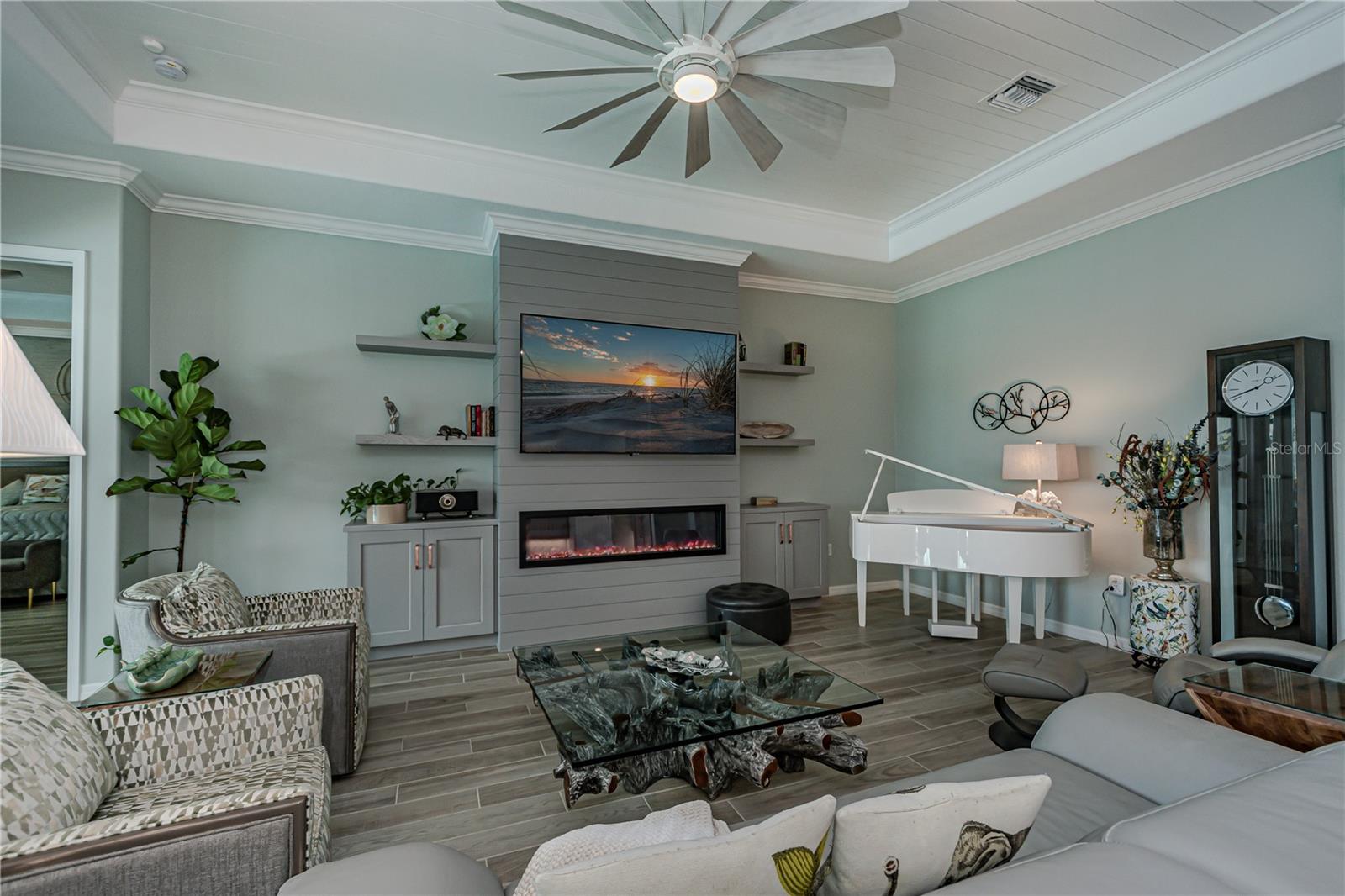 custom wall in living room w fireplace, floating shelves