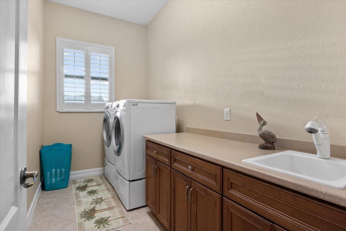 Laundry room with cabinets and sink