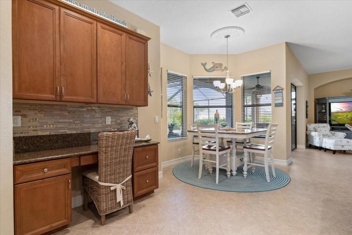 Breakfast Nook with built in desk area next to kitchen