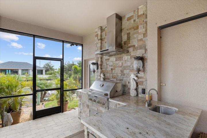 Outdoor Kitchen with built in grill hood and sink