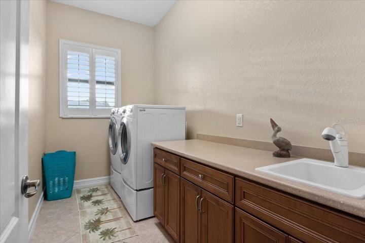 Laundry room with cabinets and sink